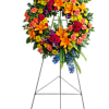 Round wreath with green hydrangea, hot pink spray roses, orange asiatic lilies