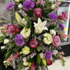 Standing Spray with roses, lilies, carnations, and mixed greens. 