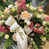 This small casket spray is made with roses, foxglove, spray roses, and