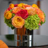Bright and cheerful blend of roses, hydrangea, protea and ranunculus in a