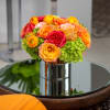 Bright and cheerful blend of roses, hydrangea, protea and ranunculus in a