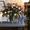 White lilies, white roses, white snapdragons, blue delphinium, blue thistle, purple alstroemerias