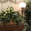 White roses, bells of Ireland, trix dianthus, and cattails, with Israeli ruscus