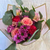 This beautiful wrapped bouquet is made with a mixture of seasonal flowers