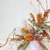 - Unique arrangement featuring yellow banksias and kiwi branches
- Delicate white accents