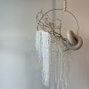- Hanging floral arrangement with calming palette of neutral tones
- Variety of