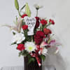 A beautiful bouquet of red roses, white carnations and red mini carns
