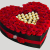 A modern flower arrangement in a heart box filled with roses &amp;