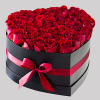 A modern flower arrangement in a heart box filled with red roses.

DETAILS
This