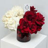 A premium arrangement of luxe roses in classy red and white. 