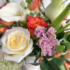 Flowers in a concrete vase that looks like bark. A beautiful gift