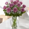 This stunning arrangement features a beautiful assortment of lavender roses, a timeless