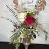 Tall floral design in glass cup.