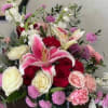 The arrangement is naturally stylized, with touches of blossomy flowers added for