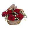 This exquisite arrangement features deep, velvety red roses artfully arranged in a