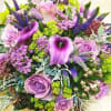 Best available selection of seasonal flowers in shades of purple and green.