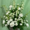 Our ETERNAL SYMPATHY arrangement is made in a white wicker basket with