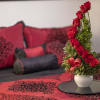 12 red roses, myrtle, and variegated greens gorgeously arranged.