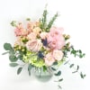 This design features long lasting cymbidium orchids, blush roses, light pink spray