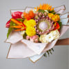 Tropical and exotic flower bouquet with King protea, roses, laceleafs and transvaal