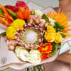 Tropical and exotic flower bouquet with King protea, roses, laceleafs and transvaal
