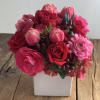 Lush mass of hot pink hydrangea, roses, ranucula and tulips in a