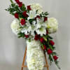 A cluster of Red Roses and White Lilies on a body of