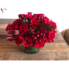 Red roses, hypericum and safari sunset in a low cylinder
