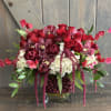 This stunning display is lush and romantic. Flowers included in this arrangement