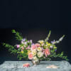 Blossoming Serenity&quot; is a graceful floral arrangement featuring soft pink roses, pale