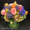 clear  vase wrap with t leave and gathered with Holland flowers