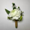 This Ranunculus Boutonniere Includes White Ranunculus, White Filler Flower, Gentle Greenery and