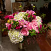 Lush and full, hydrangeas highlighting an array of pink flowers, roses dahlias