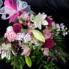 Hand wrapped assortment presentation flowers with paper and bow