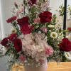 Pink and red bouquet in a ceramic head vase.
Pink head vase is