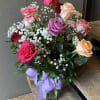 A beautiful assortment of mixed color roses, with greenery and babies breath