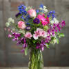 A lovely melange of garden flowers includes Delphinium, Roses, and Lillies...Tall and