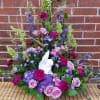 This cherub angel is set amongst a beautiful garden style arrangement of