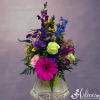 Bright and colorful mix of flowers in a metal pot topped with