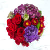 This deep jewel tone arrangement featuring red roses, purple hydrangea and purple