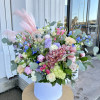 A large arrangement that sits 3ft tall with assortment of flowers 
