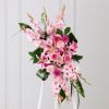 Pink gladiolas, carnations and roses accented with aspidistra and assorted greens. 