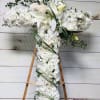 36&rdquo; cross filled with all white blooms, accented with grass and various