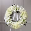 All white wreath made accented with ribbon. Base is 24&quot; wreath.