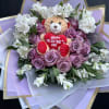 Wrapped rose and alstroemeria bouquet with teddy in middle. 
Can be made