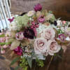 Roses, cymbidium orchids, hydrangea, pink stock, ranunculus, tulips, wax flower, berries, seeded