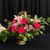 This Arrangement includes Stargazer Lily, Purple Roses, Pink Gerbera Daisies, Pink Carnations