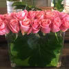 Leaf linded rectangular glass vase filled with premium roses. 