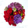 This deep jewel tone arrangement featuring red roses, purple hydrangea and purple