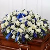 Blue and white half casket spray
Spray contains white roses, lilies, wax flower